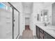 Bright bathroom featuring a glass shower, double sink vanity, and white walls at 20808 W Granada Rd, Buckeye, AZ 85396