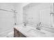 Bright bathroom featuring double sinks, a spacious mirror, and a shower over tub at 20808 W Granada Rd, Buckeye, AZ 85396