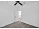 Bright carpeted bedroom with ceiling fan and a door opening to other rooms at 20808 W Granada Rd, Buckeye, AZ 85396
