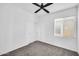 Bedroom featuring a ceiling fan, carpeted floors, closet with sliding doors and big window at 20808 W Granada Rd, Buckeye, AZ 85396