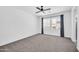 Spacious carpeted bedroom with a ceiling fan, big windows, and neutral color at 20808 W Granada Rd, Buckeye, AZ 85396