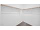 Walk-in closet with carpeted floors and simple wooden rod for storage at 20808 W Granada Rd, Buckeye, AZ 85396