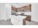 Modern kitchen features stainless steel appliances, white quartz countertops, and wood cabinets at 20808 W Granada Rd, Buckeye, AZ 85396