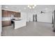 Open concept living space featuring modern kitchen, tile floors and natural light at 20808 W Granada Rd, Buckeye, AZ 85396