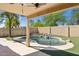 Private backyard features a covered patio and a relaxing pool with a rock waterfall feature at 2236 E Rawhide St, Gilbert, AZ 85296