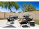 Backyard showcasing a fire pit, grill, seating, hot tub, and privacy wall creating an entertainment space at 2236 E Rawhide St, Gilbert, AZ 85296