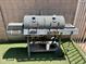 Close up of a large backyard barbecue grill with multiple cooking areas, perfect for outdoor entertaining at 2236 E Rawhide St, Gilbert, AZ 85296