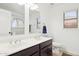 Bathroom featuring a double vanity, arched window, and contemporary finishes at 2236 E Rawhide St, Gilbert, AZ 85296