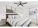 Stylish bedroom featuring neutral bedding, modern lighting, and a ceiling fan at 2236 E Rawhide St, Gilbert, AZ 85296