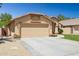 Well-maintained single-story home with a spacious concrete driveway leading to a two-car garage at 2236 E Rawhide St, Gilbert, AZ 85296