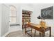 Home office features custom built-in shelving, a desk, and a window seat for a cozy workspace at 2236 E Rawhide St, Gilbert, AZ 85296