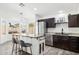 Stylish kitchen with a central island, stainless steel appliances, and views to the sunny backyard at 2236 E Rawhide St, Gilbert, AZ 85296