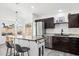 Modern kitchen with a large island, stainless steel appliances, granite countertops, and ample cabinet space at 2236 E Rawhide St, Gilbert, AZ 85296