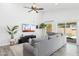 Open concept living room with tile floors, neutral paint, and bright light from the slider door at 2236 E Rawhide St, Gilbert, AZ 85296