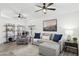 Cozy living room featuring neutral tones, comfortable seating, ceiling fans, and stylish decor at 2236 E Rawhide St, Gilbert, AZ 85296