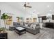 Open-concept living room featuring bright natural light, a ceiling fan, and views into the kitchen at 2236 E Rawhide St, Gilbert, AZ 85296