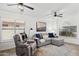 Inviting living room with large windows, comfortable seating, a ceiling fan, and a relaxed ambiance at 2236 E Rawhide St, Gilbert, AZ 85296