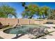 Private backyard showcasing a refreshing pool with a rock waterfall feature and artificial grass at 2236 E Rawhide St, Gilbert, AZ 85296