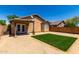 Private backyard with low-maintenance landscaping, artificial turf, and a covered patio area at 22745 W Cocopah St, Buckeye, AZ 85326