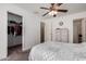 Well-lit bedroom includes a walk-in closet, ceiling fan, dresser and soft carpet at 22745 W Cocopah St, Buckeye, AZ 85326