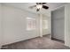 Cozy bedroom featuring soft carpet, window with blinds, ceiling fan and a sliding closet door at 22745 W Cocopah St, Buckeye, AZ 85326