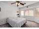 Bright bedroom with a ceiling fan, a window with blinds, and a neutral color scheme at 22745 W Cocopah St, Buckeye, AZ 85326