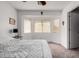 Light-filled bedroom featuring a window with blinds, neutral walls, and comfortable carpeting at 22745 W Cocopah St, Buckeye, AZ 85326