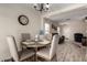 Cozy dining area featuring a round table, four chairs, and an open view into the living room at 22745 W Cocopah St, Buckeye, AZ 85326