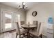 Cozy dining area with a chandelier, wood-look tile flooring, a round table, and backyard access at 22745 W Cocopah St, Buckeye, AZ 85326