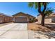 Charming single-story home features a well-maintained front yard, concrete driveway, and attached two-car garage at 22745 W Cocopah St, Buckeye, AZ 85326