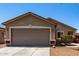 Charming single-story home with a neutral-colored exterior, well-kept lawn, and a two-car garage at 22745 W Cocopah St, Buckeye, AZ 85326