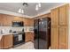 Efficient kitchen with wooden cabinets, stainless steel appliances, tile floors, and a bright, airy feel at 22745 W Cocopah St, Buckeye, AZ 85326