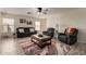 Inviting living room with neutral walls, wood-look tile floors, comfortable seating, and a ceiling fan at 22745 W Cocopah St, Buckeye, AZ 85326