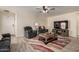 Well-lit living room with stylish furniture, tile flooring, and a welcoming front door at 22745 W Cocopah St, Buckeye, AZ 85326