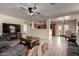 Cozy living room with an open layout, features a fireplace, tile floors, and access to a casual dining area at 22745 W Cocopah St, Buckeye, AZ 85326