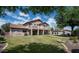 Large, well-maintained backyard with green grass, mature trees and an upper level balcony at 2307 W Sienna Bouquet Pl, Phoenix, AZ 85085