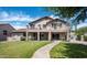 The manicured backyard features a lush lawn, covered patio, and balcony off the second story at 2307 W Sienna Bouquet Pl, Phoenix, AZ 85085