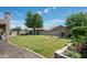 Private backyard featuring a large lawn, mature landscaping, and a privacy fence at 2307 W Sienna Bouquet Pl, Phoenix, AZ 85085