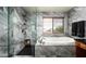 Luxurious bathroom featuring marble-style tile, a soaking tub, and a separate shower at 2307 W Sienna Bouquet Pl, Phoenix, AZ 85085