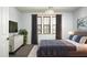 Bright bedroom features a large bed, modern dresser, and windows with wood blinds and gray drapes at 2307 W Sienna Bouquet Pl, Phoenix, AZ 85085