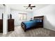 Comfortable bedroom with neutral carpet, dark furniture, and a window providing natural light at 2307 W Sienna Bouquet Pl, Phoenix, AZ 85085