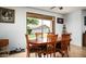 Cozy dining area features a wood table and chairs and views of the backyard at 2307 W Sienna Bouquet Pl, Phoenix, AZ 85085