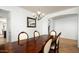Traditional dining room with dark wood table and ornate chairs beneath a decorative chandelier at 2307 W Sienna Bouquet Pl, Phoenix, AZ 85085