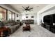 Spacious living room with cozy sofas, plush carpeting, and a large TV at 2307 W Sienna Bouquet Pl, Phoenix, AZ 85085
