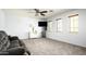 Living room with a ceiling fan, neutral carpet, and large windows at 2307 W Sienna Bouquet Pl, Phoenix, AZ 85085