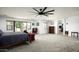 Spacious main bedroom with large windows, neutral carpet, and a view of the ensuite bathroom at 2307 W Sienna Bouquet Pl, Phoenix, AZ 85085