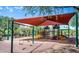 A colorful covered playground includes slides, swings, and climbing structures for community children at 2307 W Sienna Bouquet Pl, Phoenix, AZ 85085