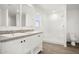 Bathroom featuring dual sinks, white cabinets, and tiled shower at 23117 W Duane Ln, Wittmann, AZ 85361