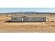 Single-story home featuring a white front door, neutral siding, and mountain views at 23117 W Duane Ln, Wittmann, AZ 85361