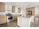 Bright kitchen featuring stainless steel appliances and a center island at 23117 W Duane Ln, Wittmann, AZ 85361